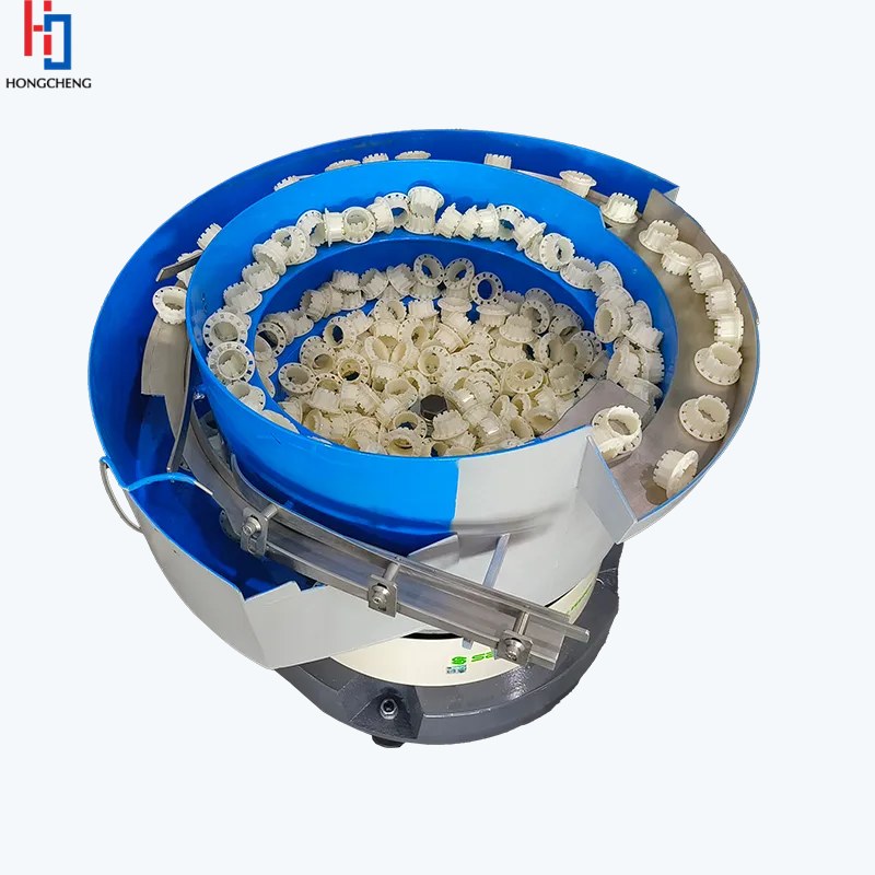 Enclosed vibratory feeding system for small rubber components